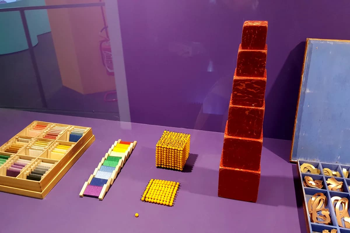 Traditional Montessori educational materials and wooden sensory objects arranged on low open shelving